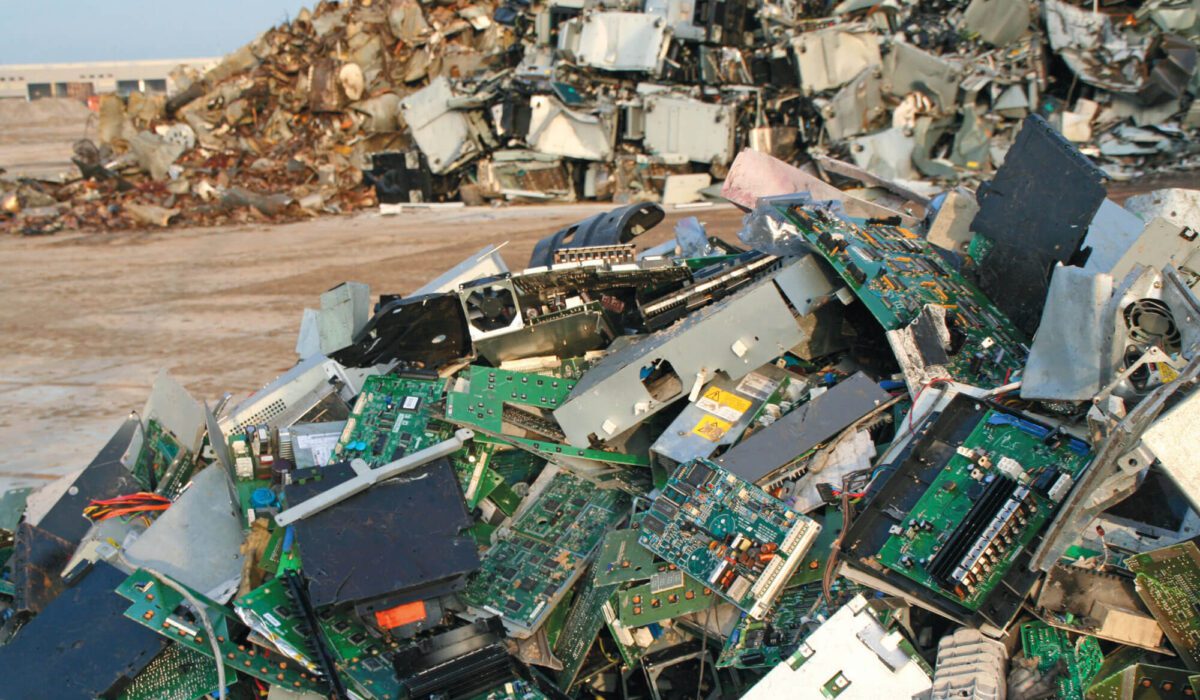 Pile of e-waste, like computers and circuit boards, in a landfill.