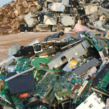 Pile of e-waste, like computers and circuit boards, in a landfill. Credit: istock.