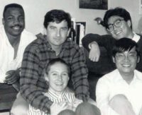 Black and white photo of five friends, four men and one woman.