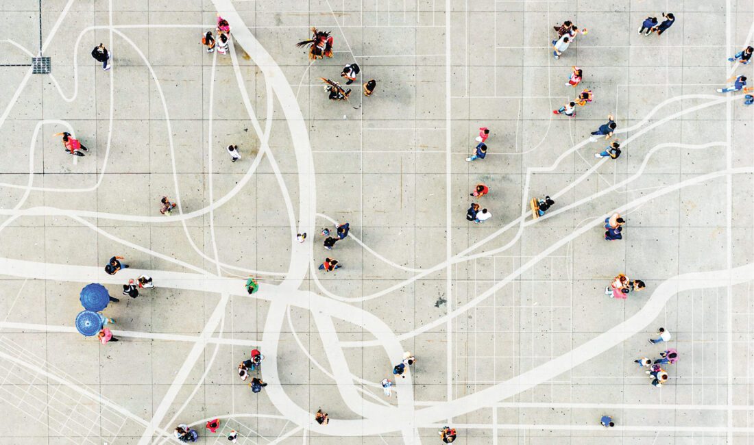 Arial view of people walking overlaid on a map painted on the concrete.