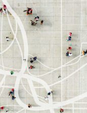 Arial view of people walking overlaid on a map painted on the concrete.