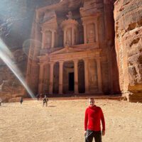 Man standing in front of an ancient site in Jordan.