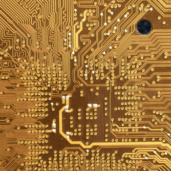 Up close photo of a gold microchip.