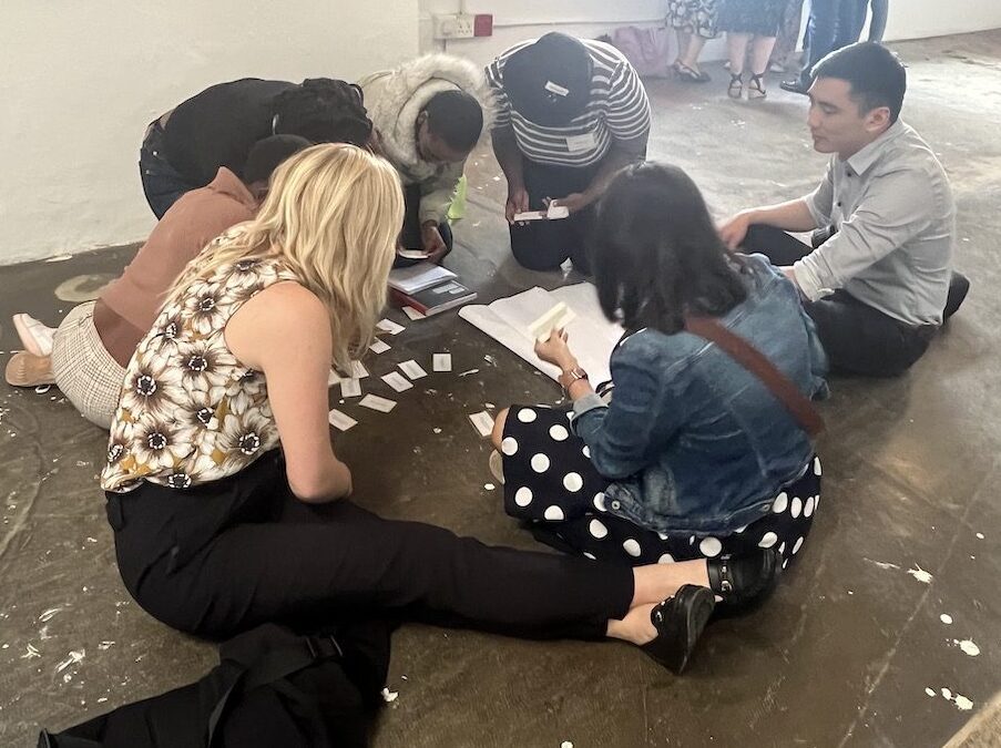 a group of students sitting in a circle working on a project.