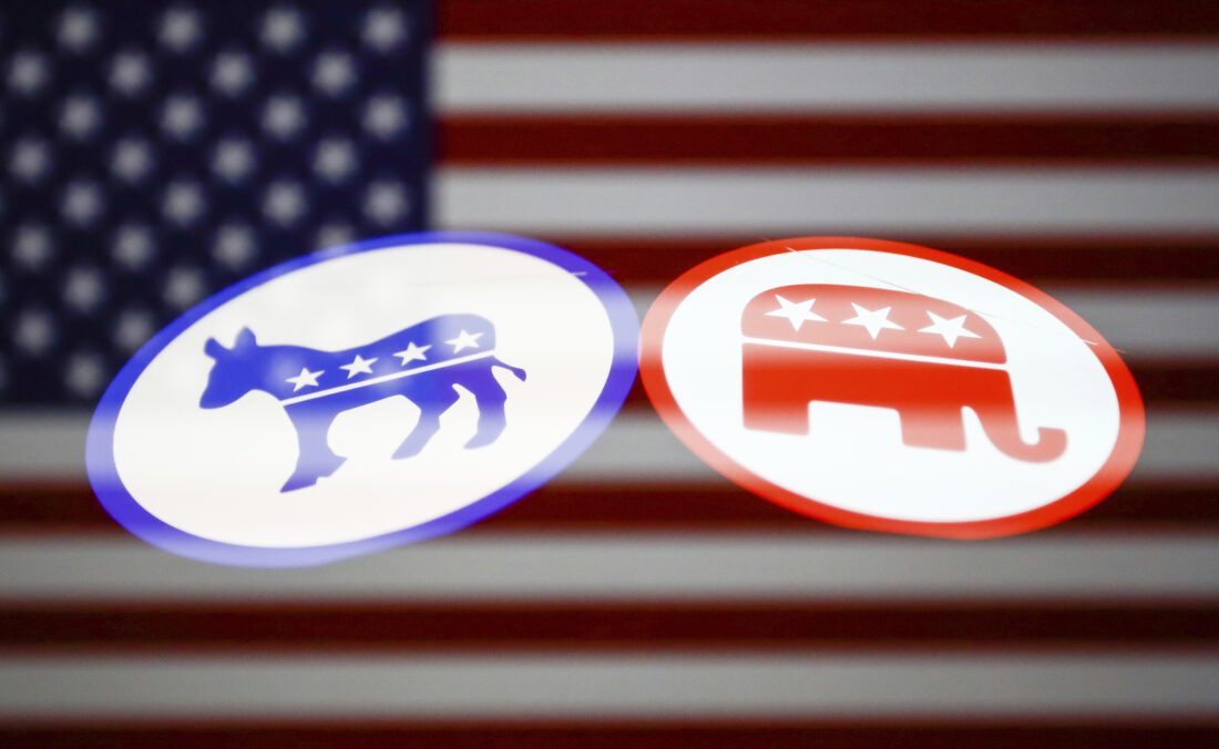 Democratic donkey emblem and Republican elephant with their backs turned toward each other on an American flag are seen in this multiple exposure illustration photo.