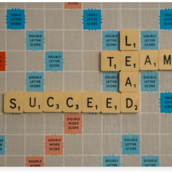 Picture of Scrabble gameboard with the words "succeed", "lead" and "team" spelled out.