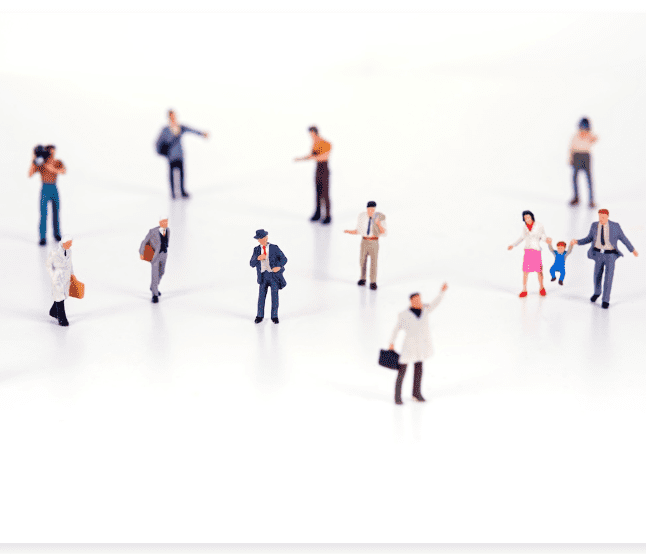 Photo of to figures of people, a couple, a family with their child against a white backdrop.