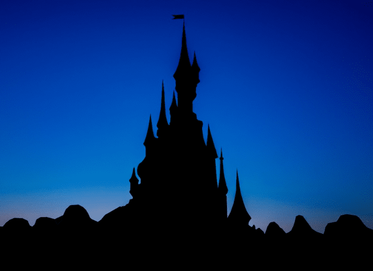 Outline of a Disneyland Castle. Against a Blue backdrop.