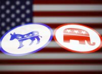 Democratic donkey emblem and Republican elephant with their backs turned toward each other on an American flag are seen in this multiple exposure illustration photo.