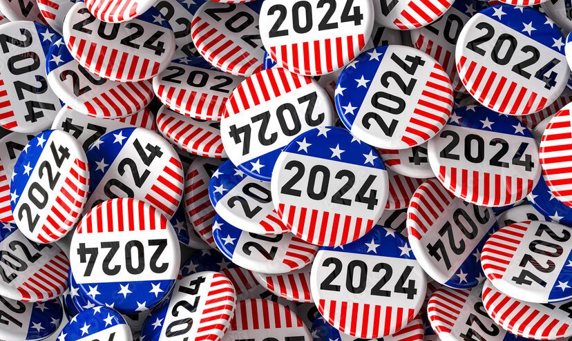 A pile of 2024 election buttons with American flag backdrops.