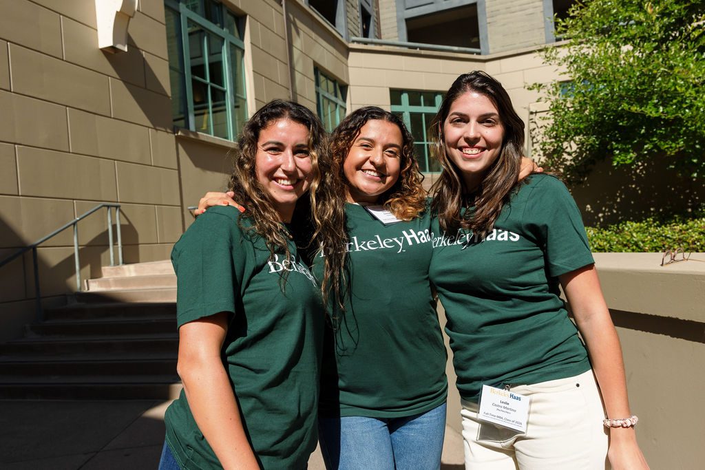 three women wearing green Haas tshirts.