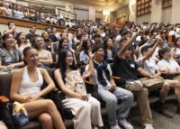 undergrad students sitting in auditorium in a big group