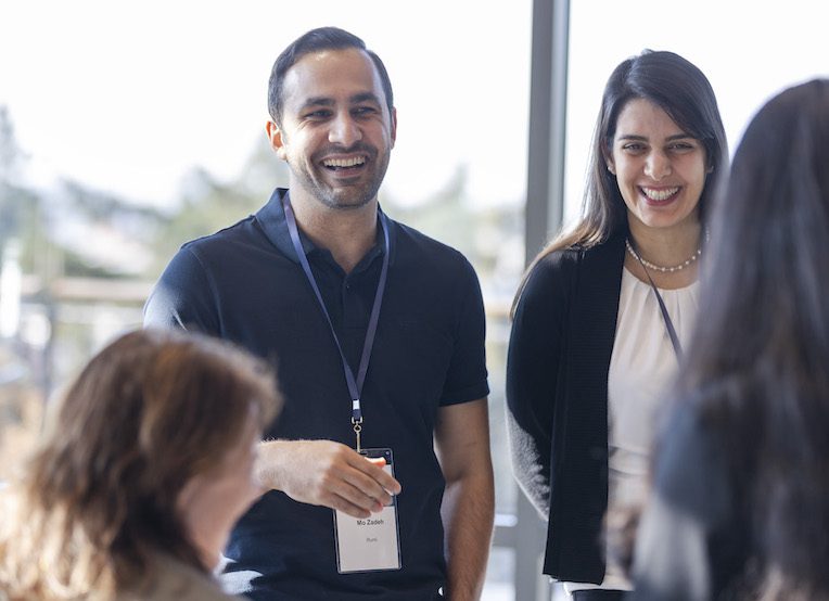 man and woman talking to a group during LAUNCH