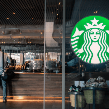 Photo of a Starbucks logo on an actual Starbucks glass window or door of storefront.