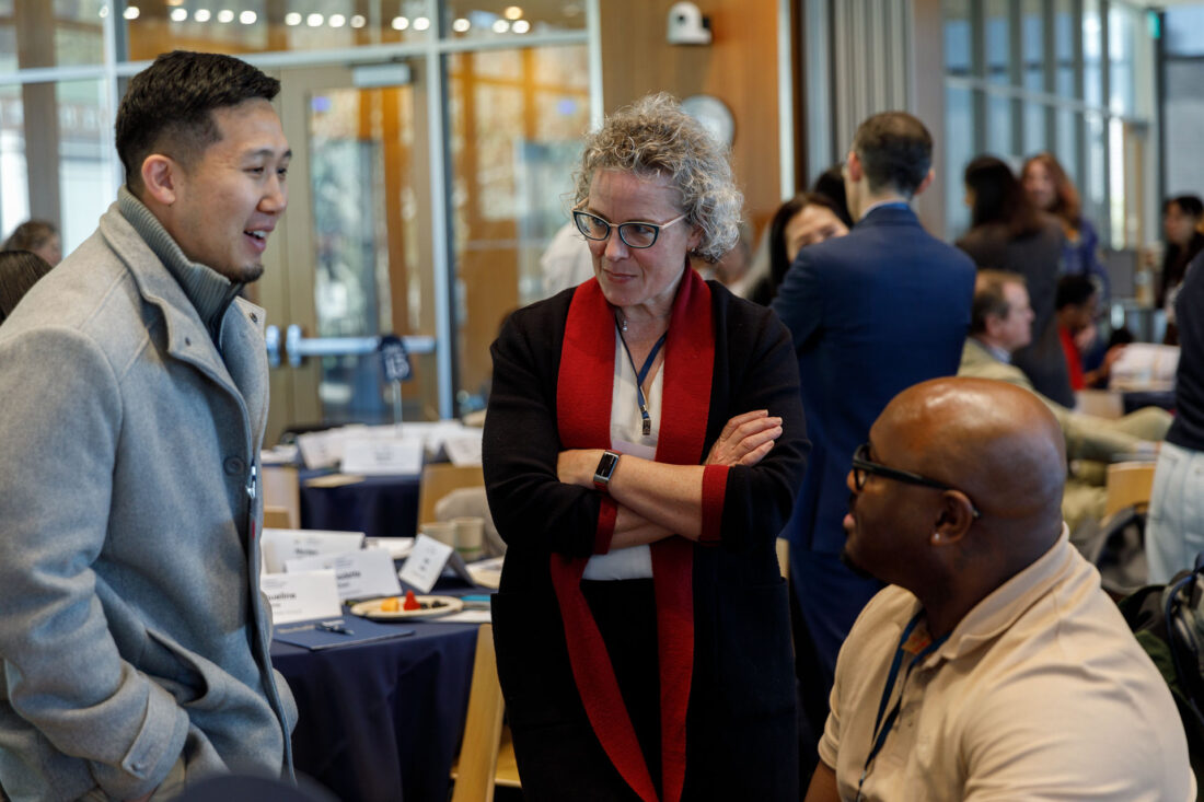 Two men and a woman chat during a break at the Culture Connect Conference.